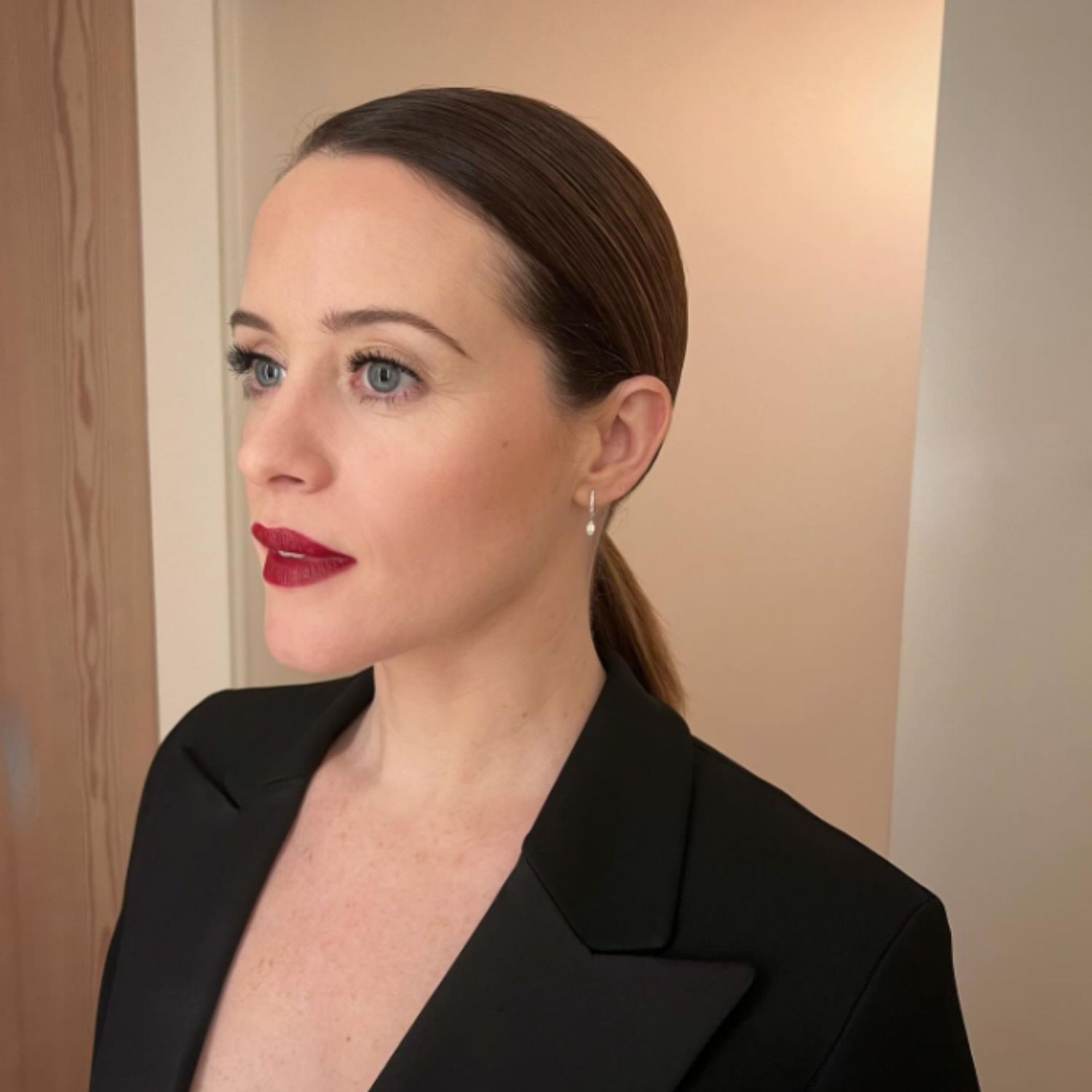 Claire Foy with natural makeup and smudge-y dark red lip.