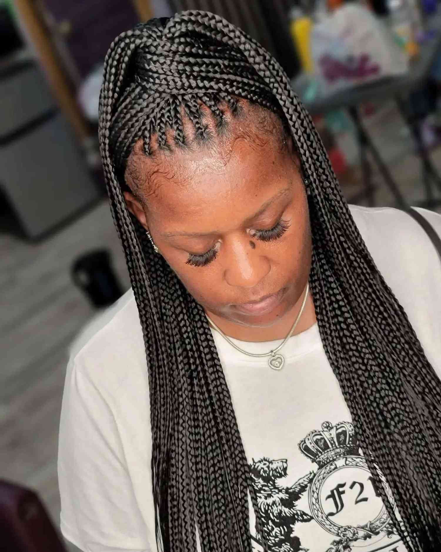 Knotless braids in a twisted high ponytail