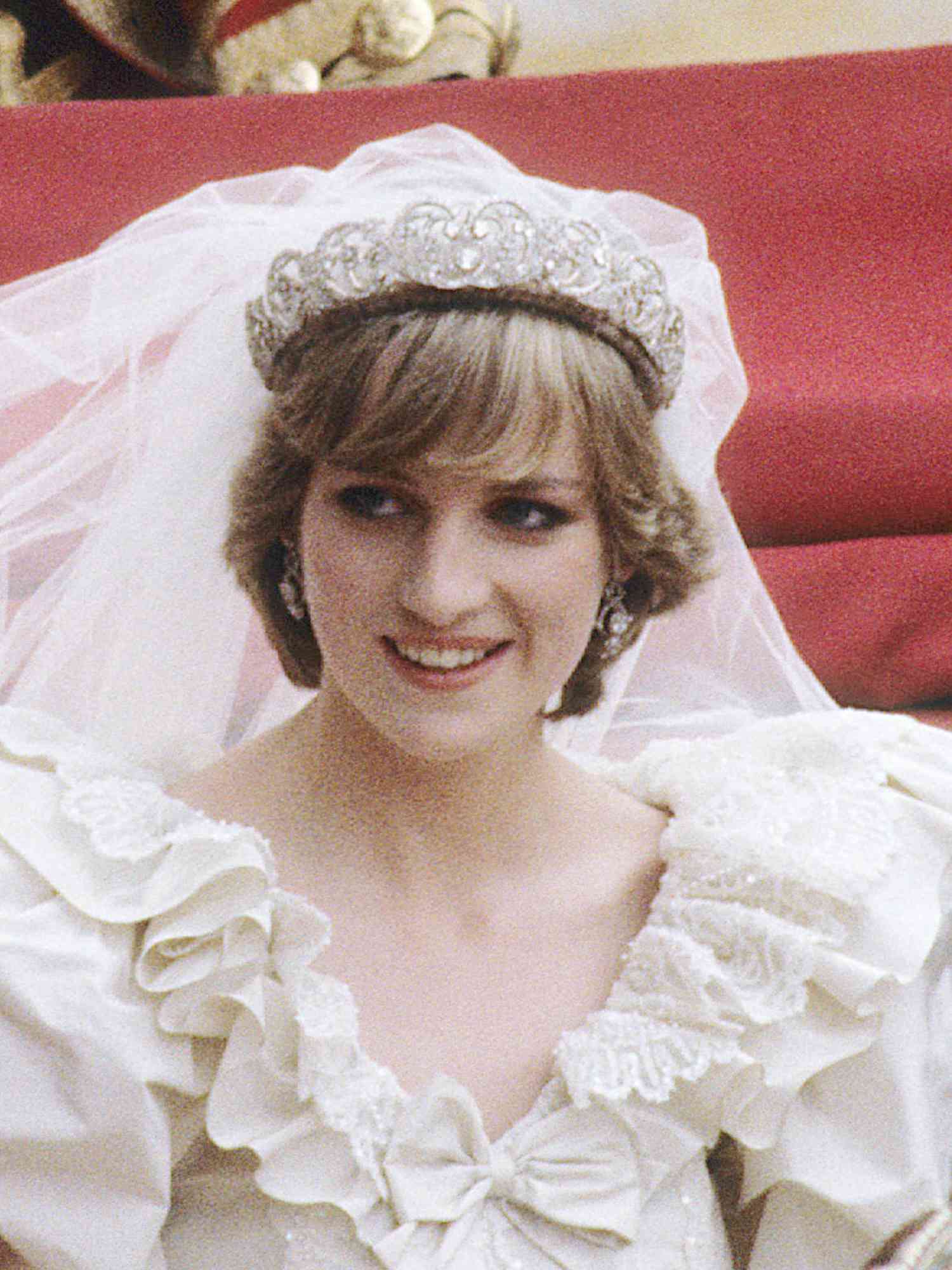 Princess Diana wearing a flippy short hairstyle with bangs, a tiara, and a veil on her wedding day