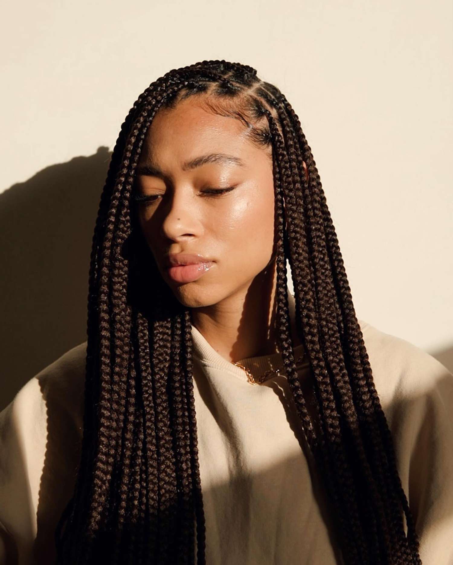 A woman with long knotless box braids 