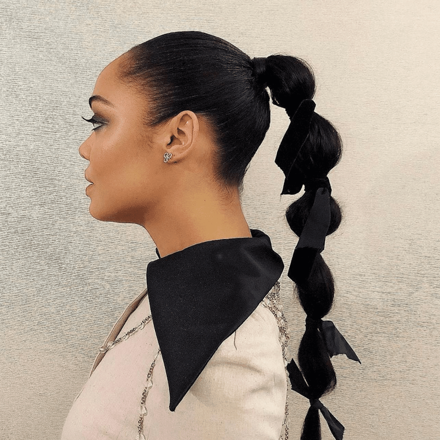 Tessa Mae Thompson wears a bubble ponytail adorned with black ribbons 