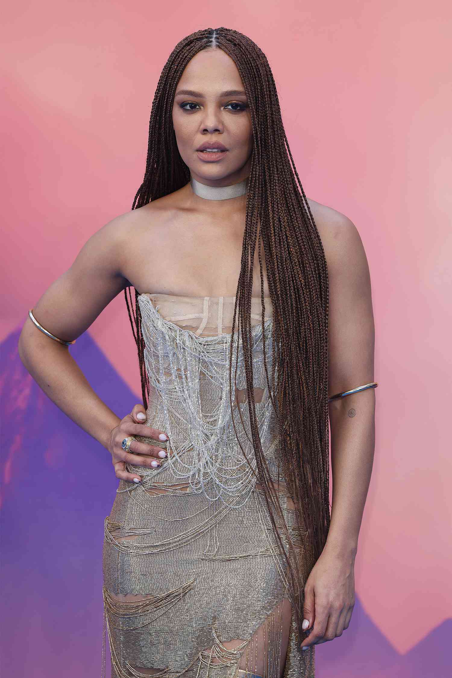 Actor Tessa Thompson with long box braids parted down the middle